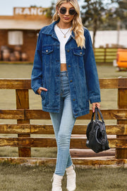 Oversized denim trucker jacket in medium blue with classic button front and chest pockets.