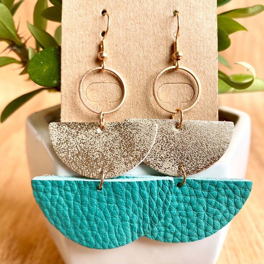 Textured leather & metallic half-moon earrings in aqua and gold with hammered finish.
