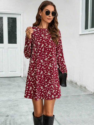 Deep red floral swing mini dress with long sleeves and round neck.