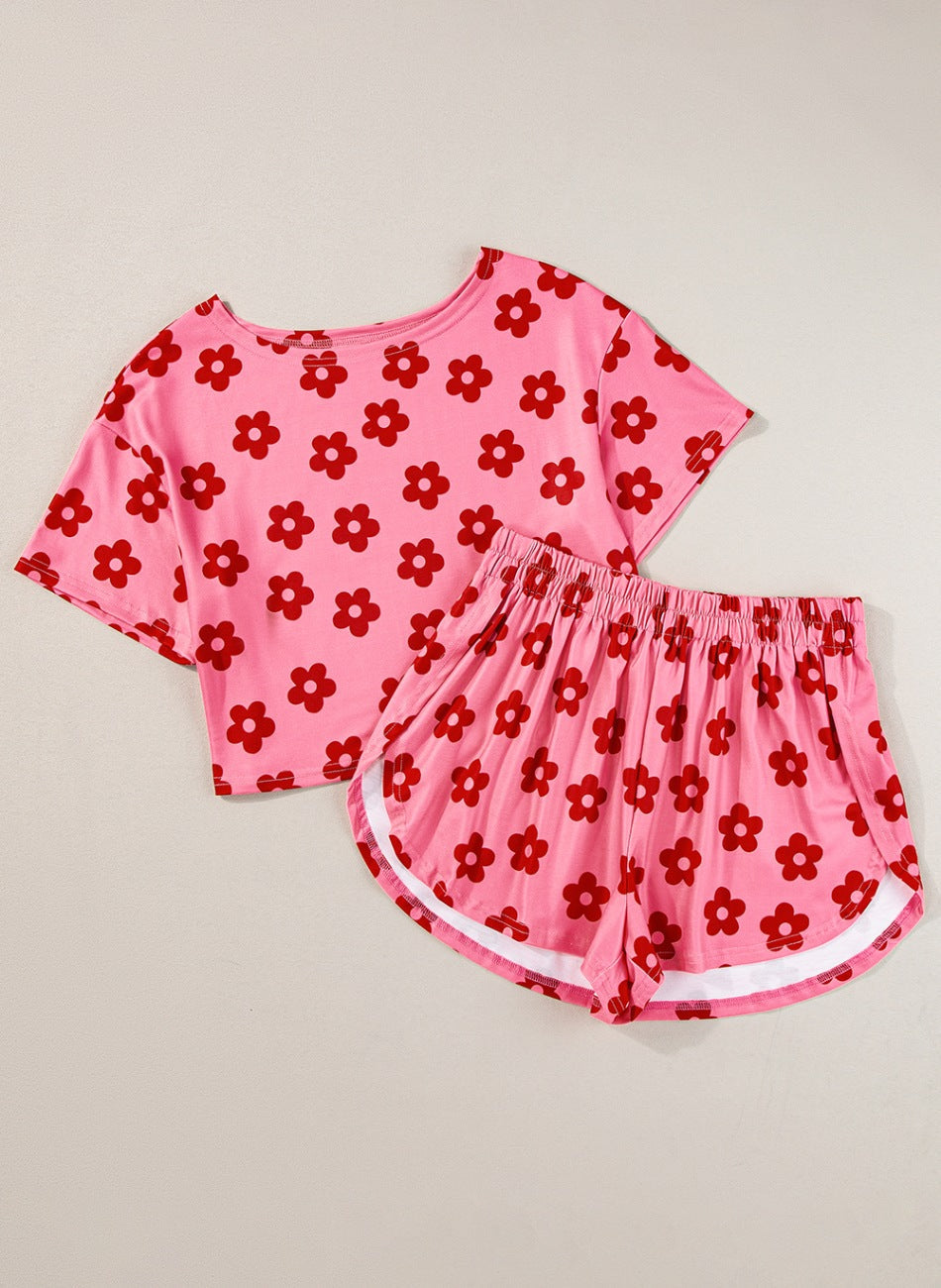 Coral pink floral crop top and shorts set with white trim on shorts.