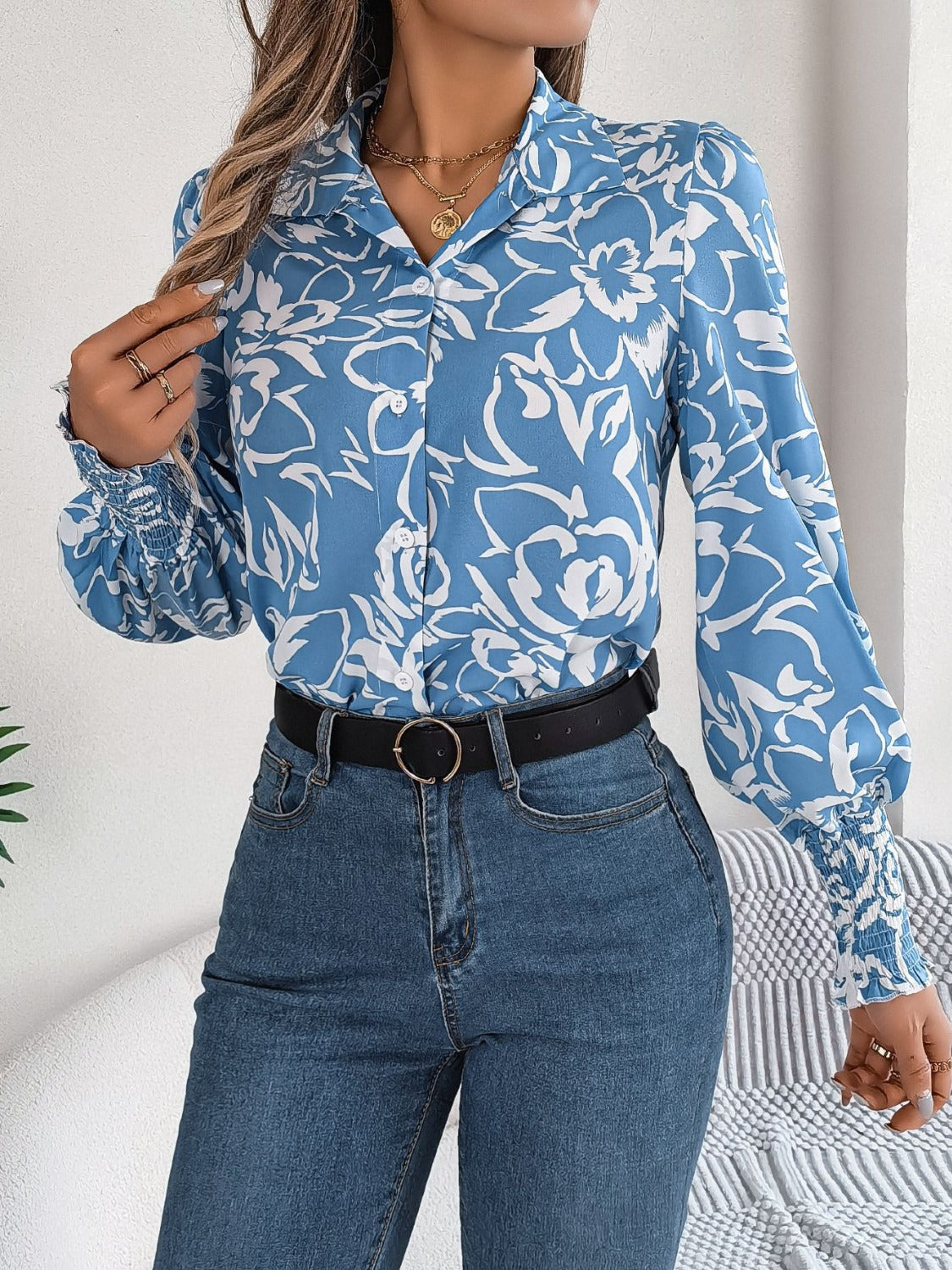 Light blue floral print blouse with shirred cuffs and buttoned front.