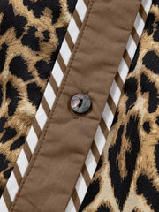 Chic leopard print two-piece set with buttoned shirt detail and striped trim.