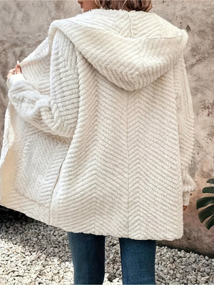 Ivory textured chevron hooded cocoon coat with a cozy, casual fit.
