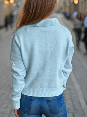 Pastel blue acrylic knit cardigan with pearl embellished snowflake detail on sleeve