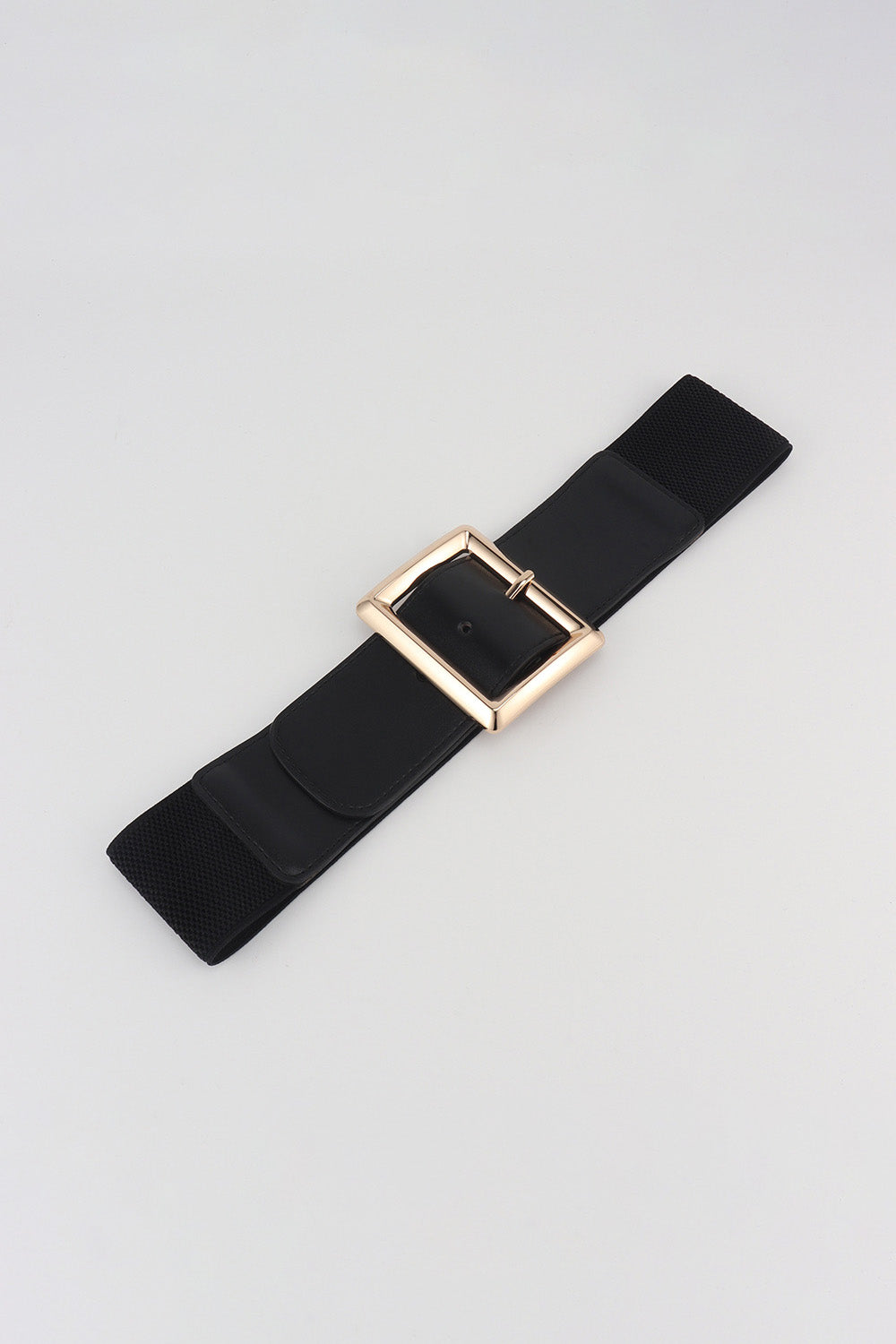 Black elastic belt with a sculptural gold square buckle and adjustable fit.