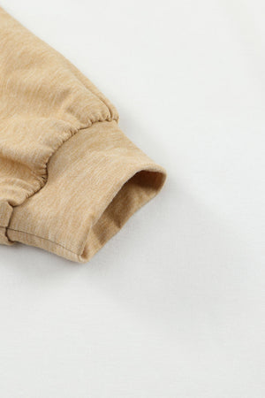 Tan slouchy knit sweater sleeve detail with gathered cuff