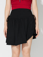 Black draped wrap mini skirt with asymmetric hem and tie detail.