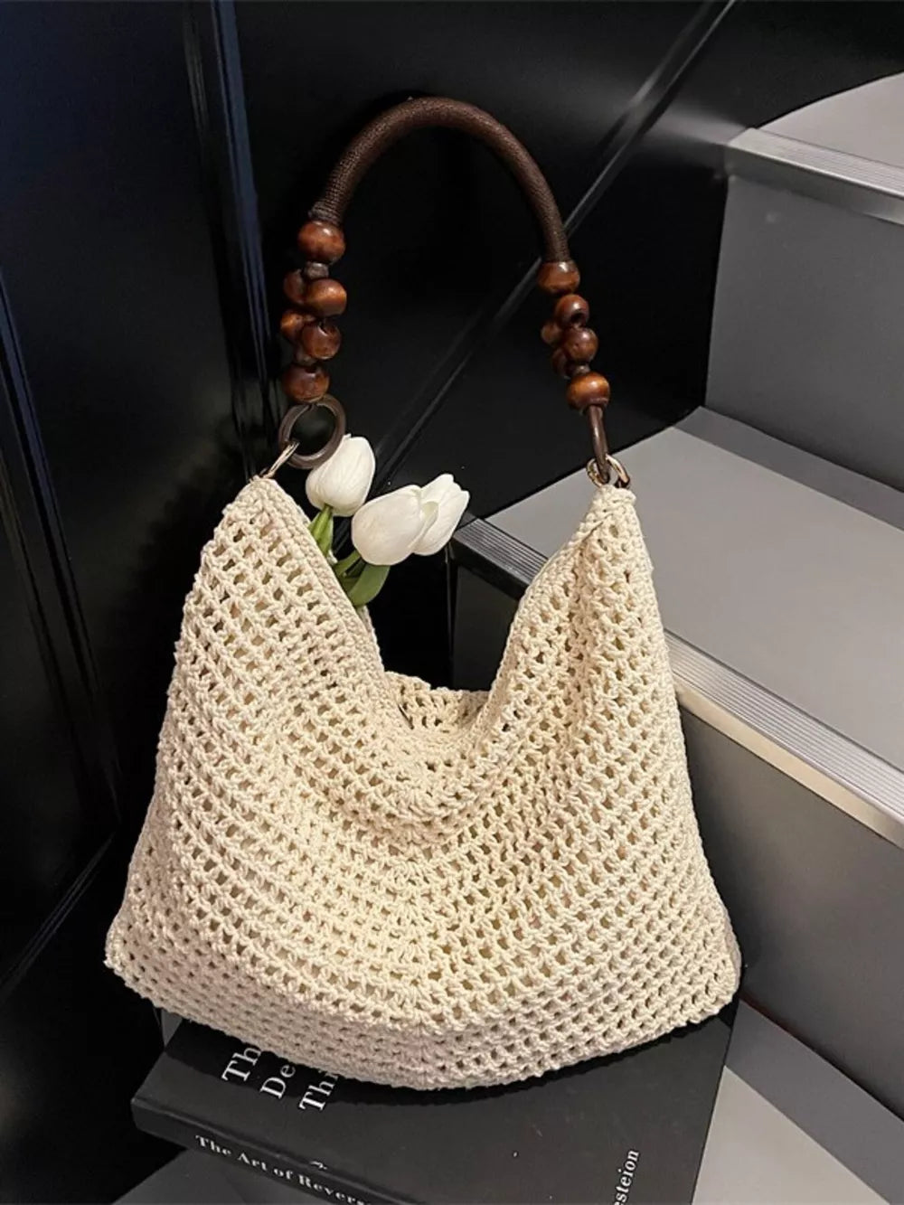 Ivory textured knit shoulder bag with wooden bead handle and boho styling.