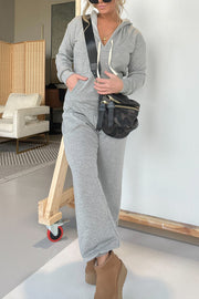 Gray hooded lounge jumpsuit with wide leg pants and drawstring detail