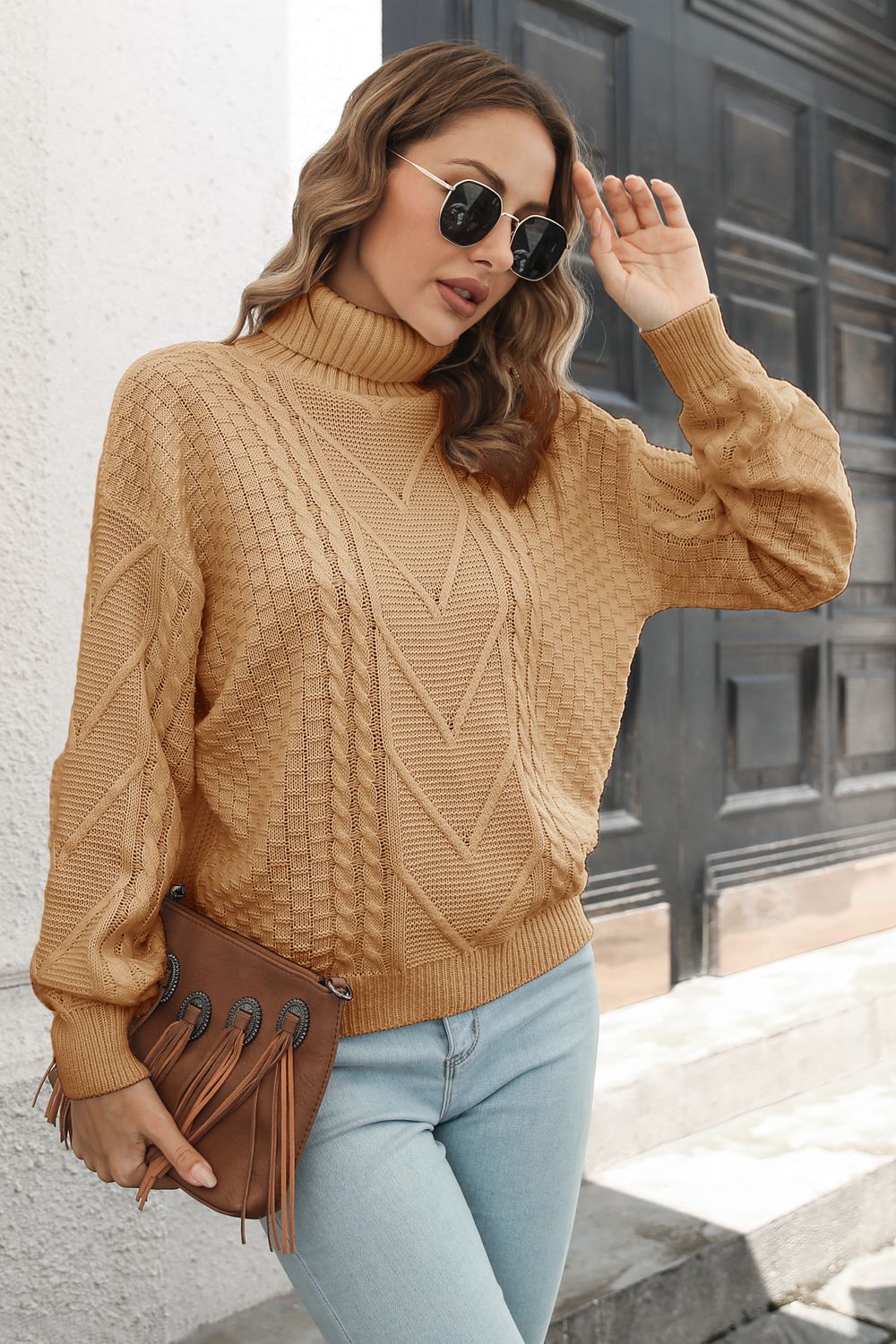 Camel cable knit turtleneck sweater with chevron pattern and acrylic material.