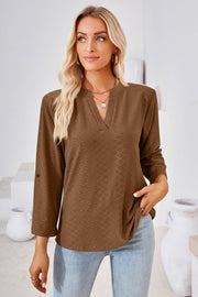 Brown textured henley blouse with rolled sleeves and V-neck.