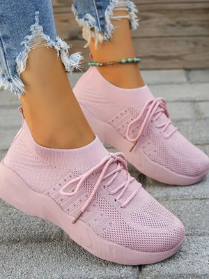 Dusty Pink knit runner sneakers with sculpted sole and lace-up closure.