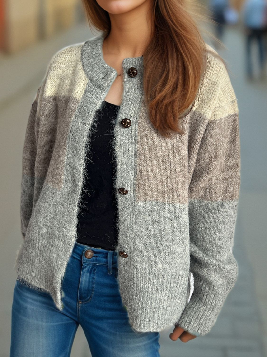 Colorblock crewneck button-down cardigan in acrylic with brown buttons.