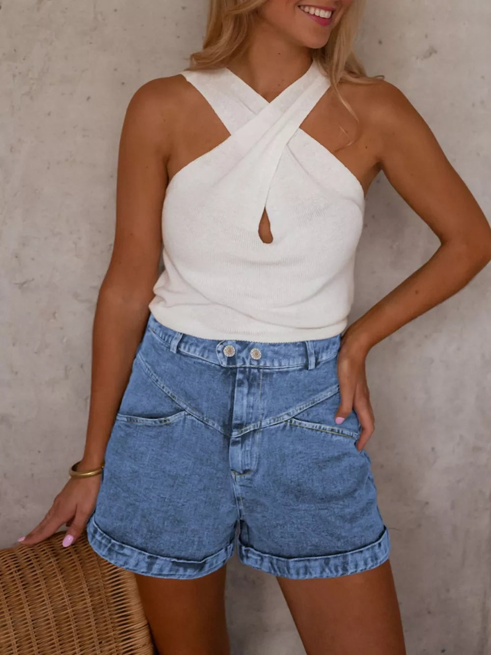 Elevated high-waist denim shorts in blue with cuffed hems and angular front detail.