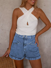 Elevated high-waist denim shorts in blue with cuffed hems and angular front detail.