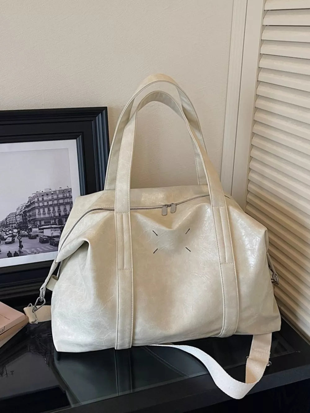 Cream white distressed vintage leather travel organizer bag with double zippers and shoulder strap.