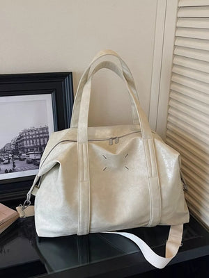 Cream white distressed vintage leather travel organizer bag with double zippers and shoulder strap.