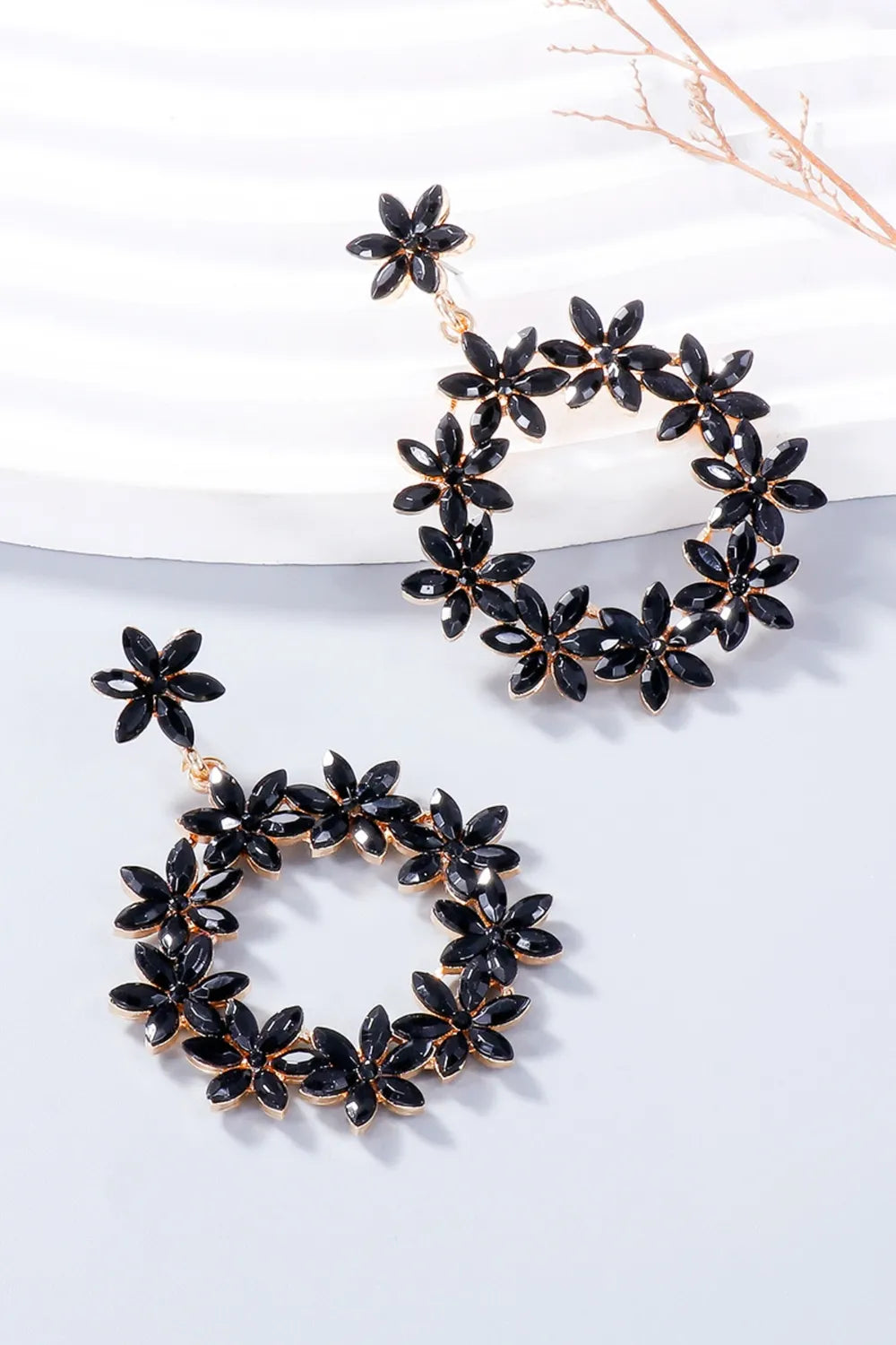 Black floral halo drop earrings with gold alloy accents.
