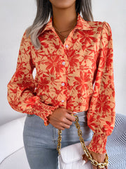 Floral print blouse in pumpkin with shirred cuffs and button front.