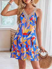 Blue A-line dress with tropical floral print and crochet V-neck detail.