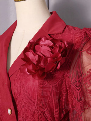 Red lace midi dress with a large floral applique and button placket detail.