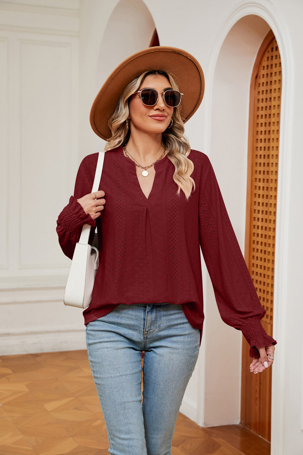 Wine eyelet detail poet sleeve blouse with split neckline and smocked cuffs.