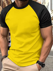 Colorblock raglan tee in gold with black sleeves and neckline.