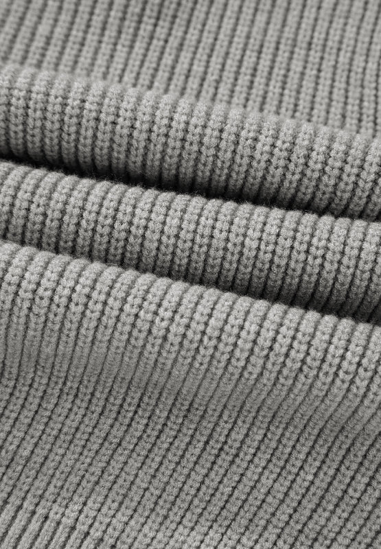 Gray ribbed knit cardigan detail showing texture and fabric weave.