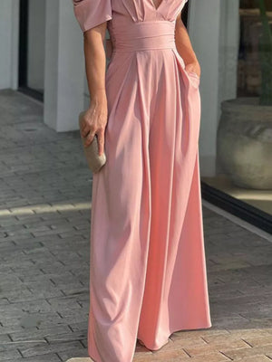 Watermelon pink romper with cinched waist, deep V-neck, and puff sleeves.