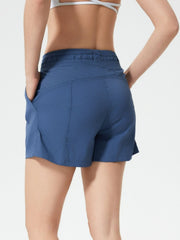 Coastal drawstring utility shorts in dusty blue with side pockets and elastic waistband.