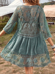 Teal lace tiered mini dress with crochet trim and floral embroidery.