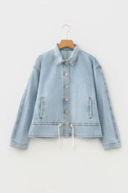 Light wash cotton denim jacket with button-down front and adjustable draw-cord hem