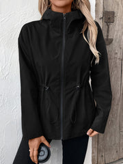 Black utility jacket with cinched waist, drawstring details, and hood.