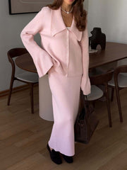 Pink ribbed knit cardigan with bell sleeves and button front, paired with a matching midi skirt.