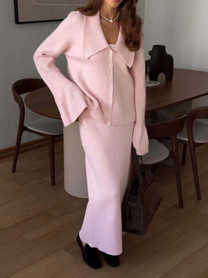 Pink ribbed knit cardigan with bell sleeves and button front, paired with a matching midi skirt.