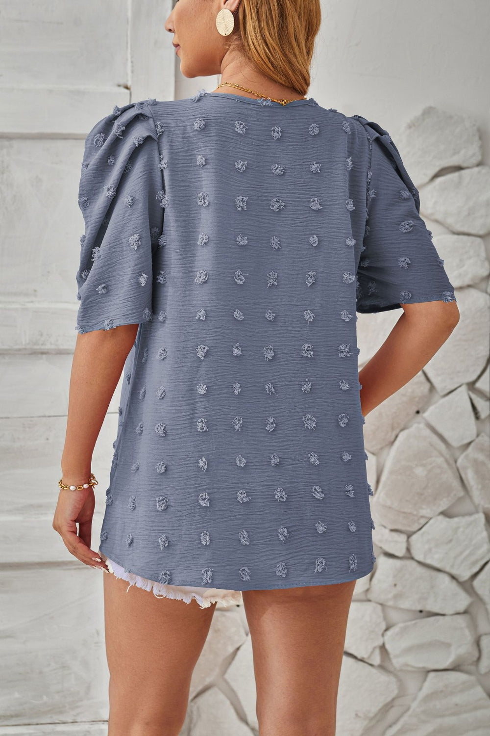 Textured puff-sleeve blouse in Dusty Blue with pom-pom details and a casual fit.