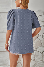 Textured puff-sleeve blouse in Dusty Blue with pom-pom details and a casual fit.