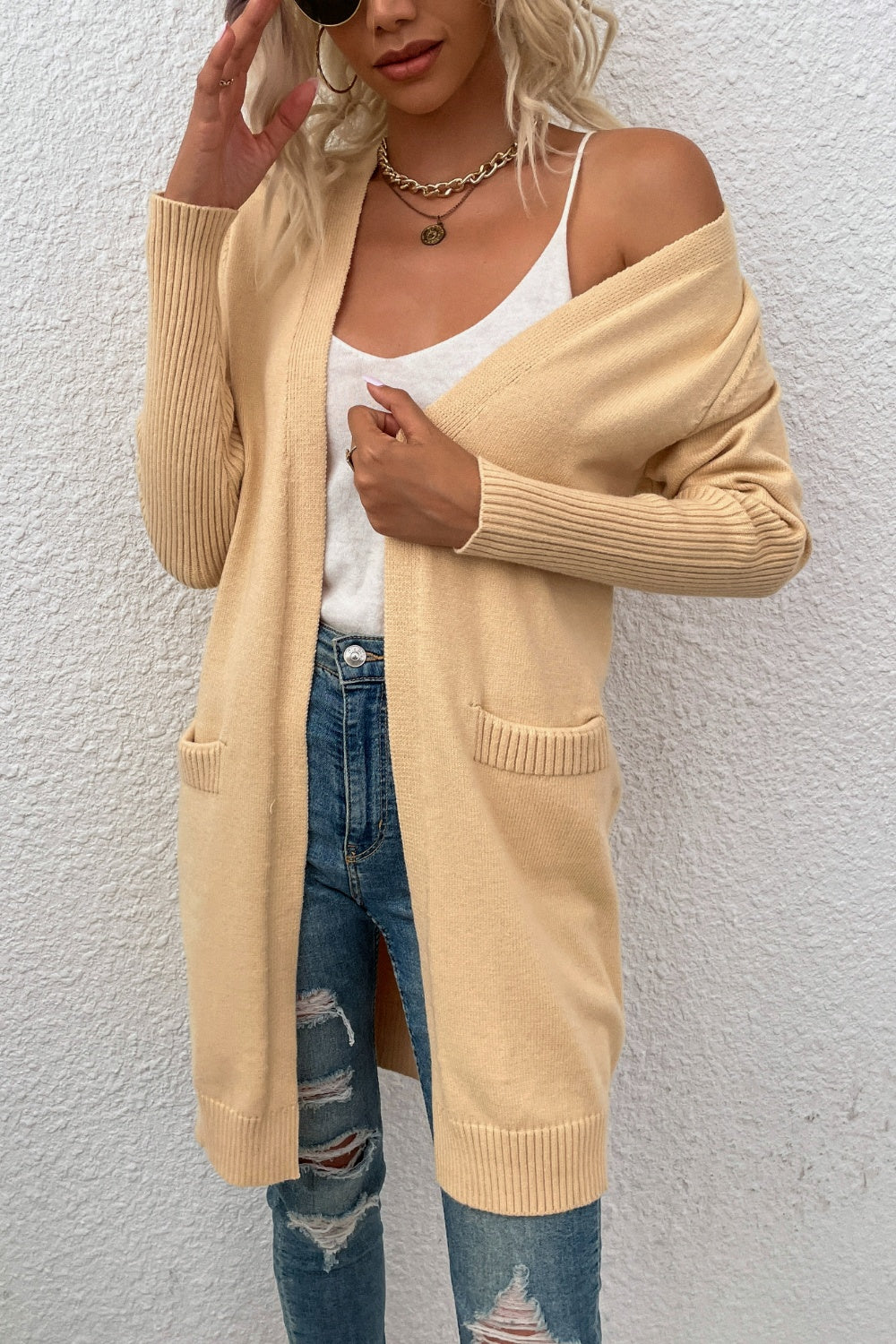 Khaki ribbed cuff open-front cardigan with pockets, styled with a white tank and ripped jeans.