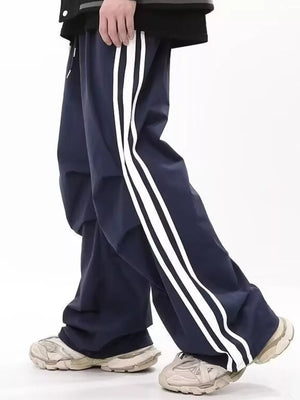 Navy wide-leg sweatpants for men with white side stripes and drawstring detail.