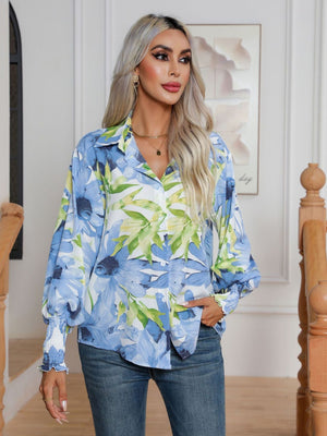 Light blue floral print blouson sleeve button-up shirt with smocked cuffs.