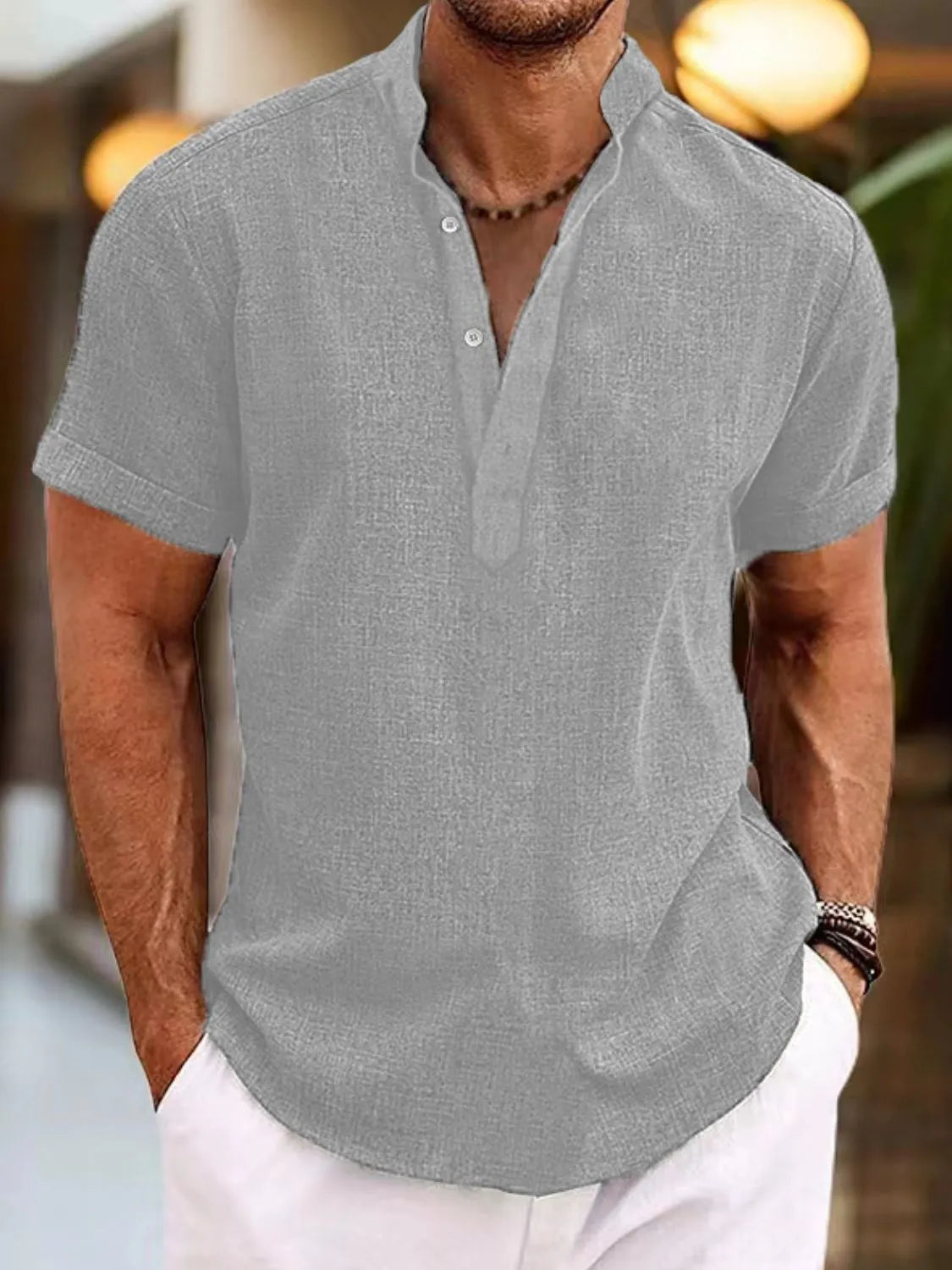 Gray linen blend henley shirt with mandarin collar and short sleeves.