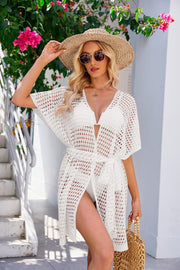 White crochet cover-up with tie waist, V-neck, short sleeves, and side slits.
