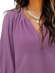 Lilac blouse with notched V-neck, 3/4 sleeves, and button-down detail.