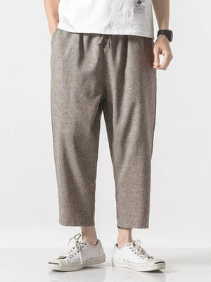Men's relaxed fit cropped sweatpants in brown with drawstring waist and cuffed hem.