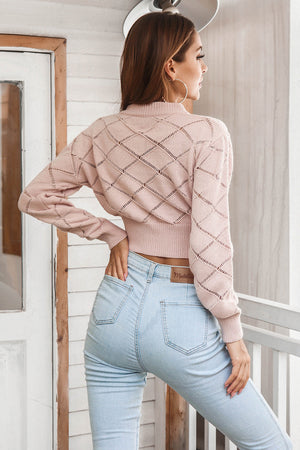 Blush pink diamond knit cropped sweater with a mock neck and long sleeves.