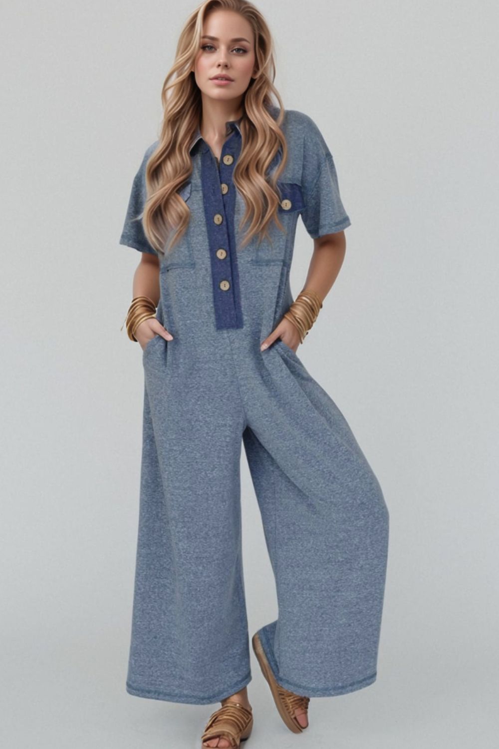 Denim-trimmed dusty blue wide-leg utility jumpsuit with button front and short sleeves.