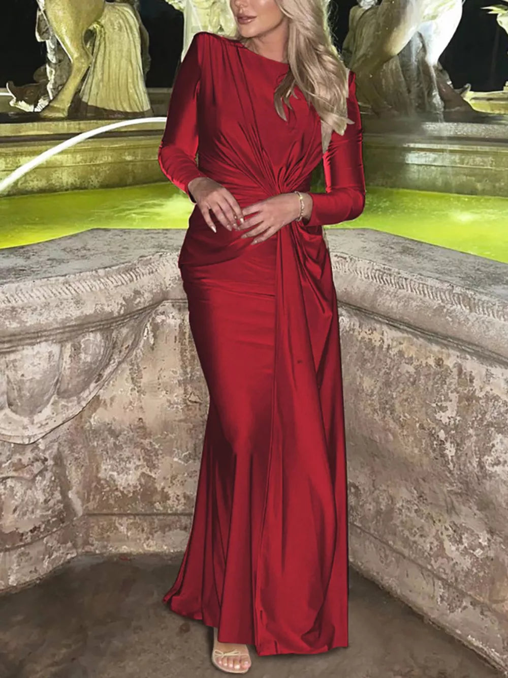 Red ruched long sleeve maxi dress with boat neckline and draped detail.