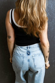 Black ribbed tank top with contrast white trim on neckline and straps
