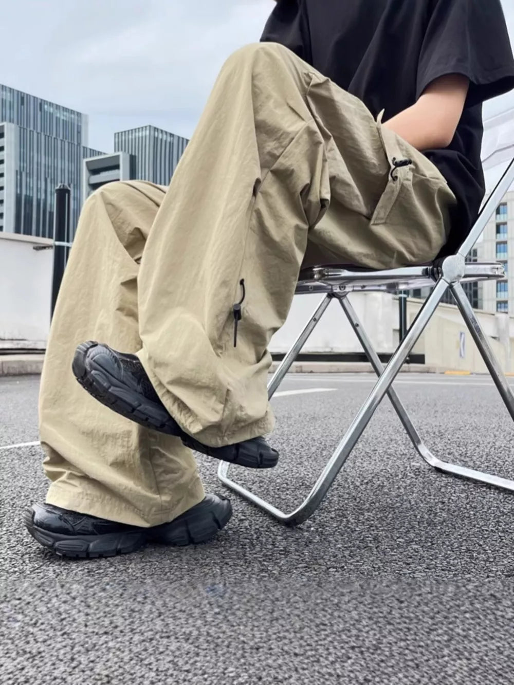 Khaki cargo sweatpants with adjustable drawstring ankles and multiple pockets.