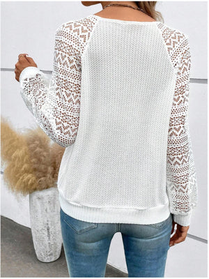 White waffle knit top with intricate lace sleeves and yoke detail.